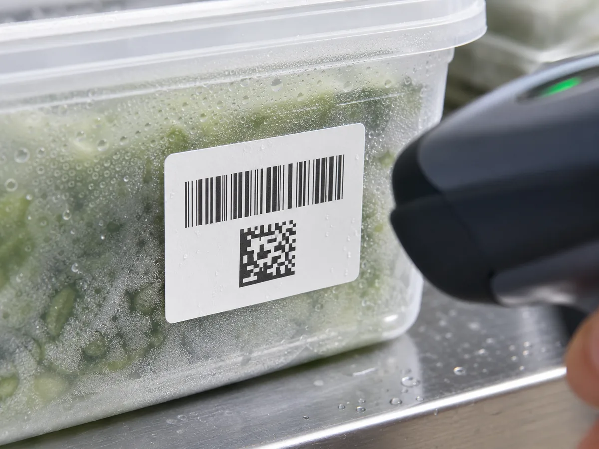 Barcode label on a cold container with moisture and scanner nearby